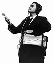 man with a headphones and a microphone attached to a portable recording device
